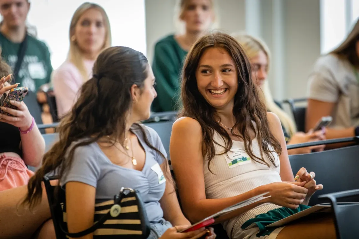 Two students chat before the new student session.